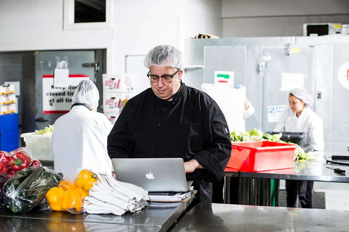 Steven Levine, resident chef at Munchery, works on his computer at the company's kitchen in San Francisco, Calif. on Tuesday, April 19, 2016.