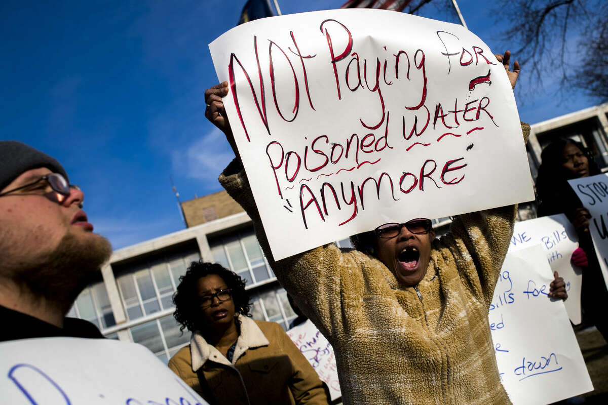 Flint resident Angela Hickmon, 56, chants during a protest outside City Hall in downtown Flint, Mich., Monday, Jan. 25, 2016. Michigan's attorney general named a former prosecutor on Monday to spearhead an investigation into the process that left Flint's drinking water tainted with lead, though Democrats questioned whether the special counsel would be impartial. (Jake May/The Flint Journal-MLive.com via AP)
