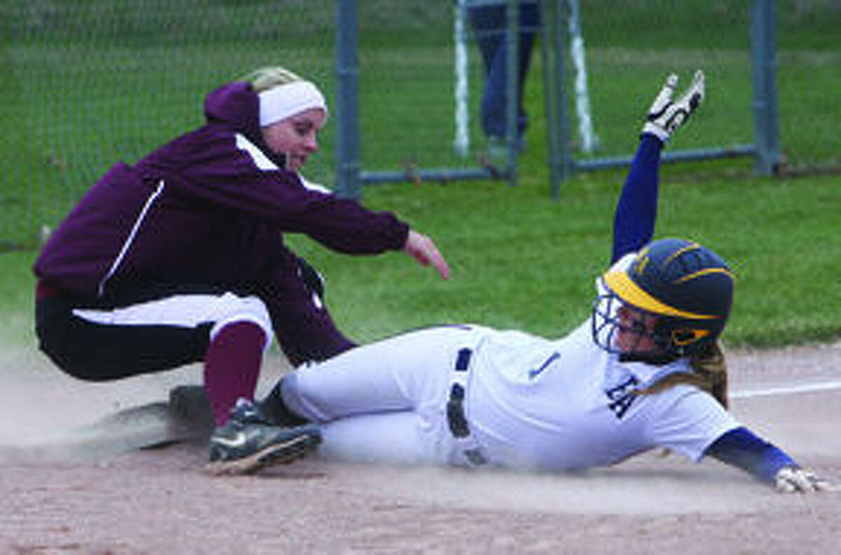 Cass City third baseman Shania Chambers tags Bad Axe baserunner Lexie Shemka out at third in Game 1, Monday in Cass City. 