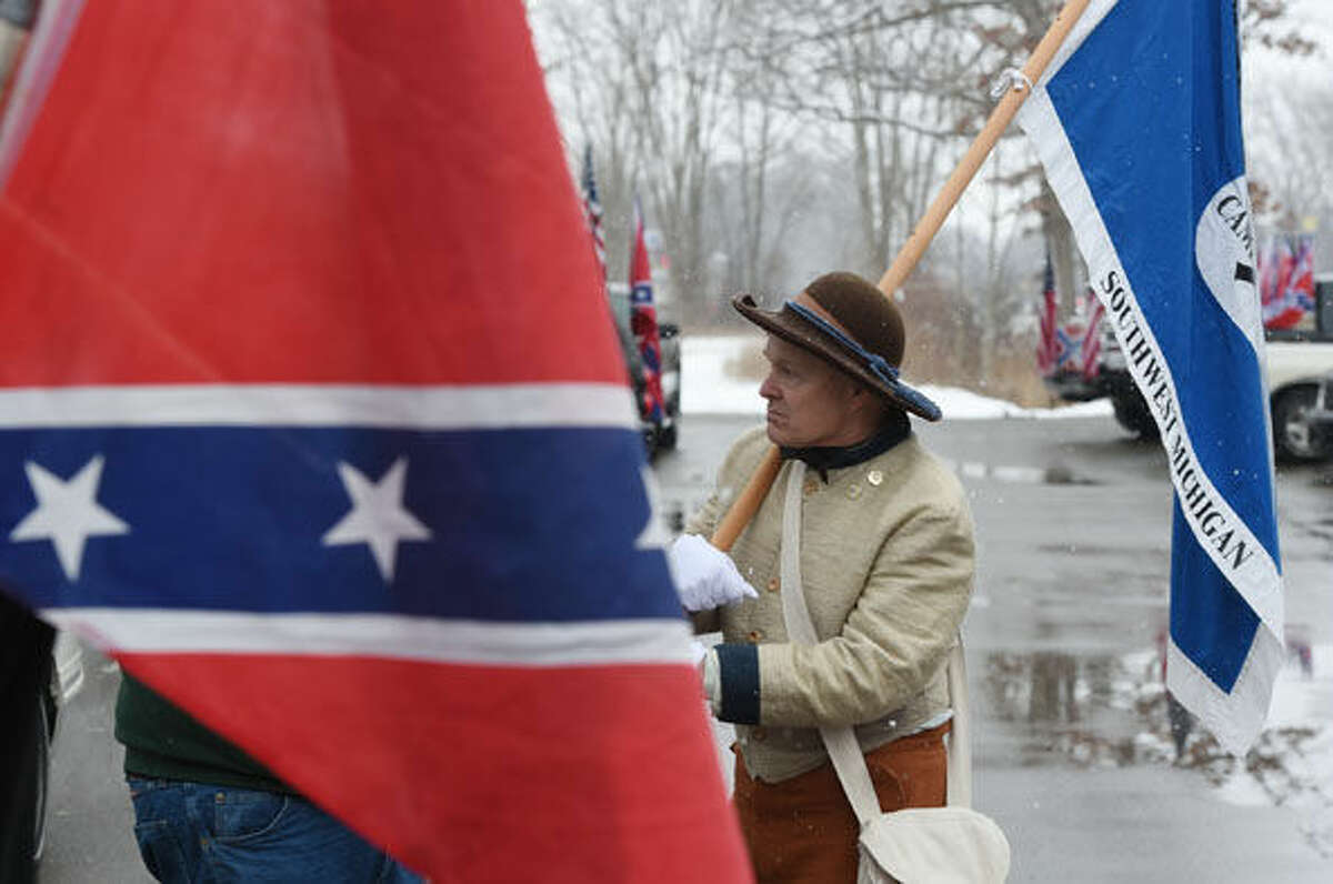 Jim Perkins of Blanchard, Mich., talks during a Confederate flag rally Saturday afternoon, March 5, 2016, in a carpool lot in Columbia Township, southwest of Detroit. About 30 people from across the state gathered with flags. (J. Scott Park/Jackson Citizen Patriot via AP))