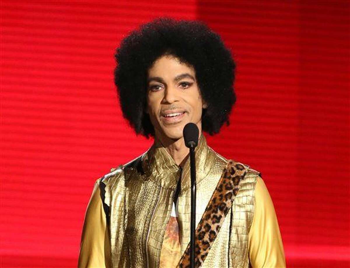 In this Nov. 22, 2015 file photo, Prince presents the award for favorite album - soul/R&B at the American Music Awards in Los Angeles. Authorities are investigating a death at Paisley Park, where pop superstar Prince has his recording studios. Jason Kamerud, Carver County chief sheriff's deputy, tells the Minneapolis Star Tribune that the investigation began on Thursday morning, April 21, 2016. (Photo by Matt Sayles/Invision/AP)