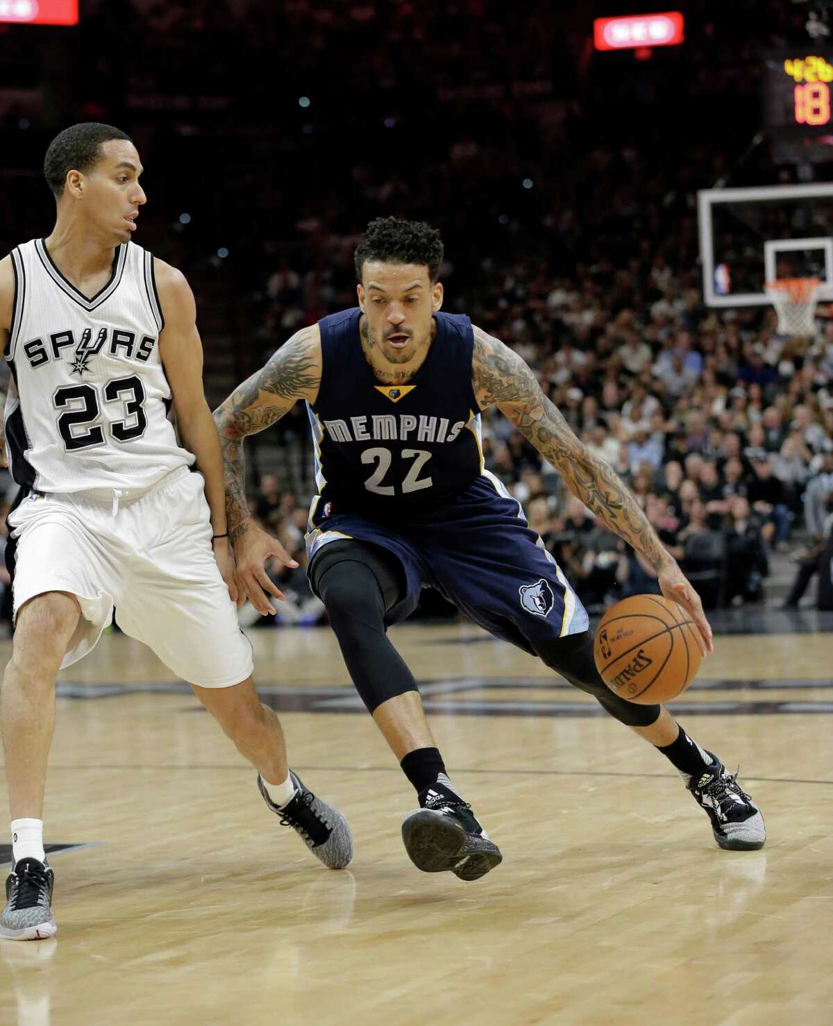 Memphis Grizzlies forward Matt Barnes (22) drives around San Antonio Spurs guard Kevin Martin (23) during the first half in Game 2 of a first-round NBA basketball playoff series, Tuesday, April 19, 2016, in San Antonio.