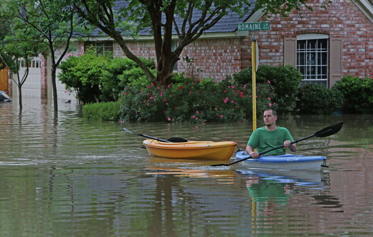 Residents use small boats to deliver goods to neighbors and take them out of their homes near Nanes and Baltic Wednesday, April 20, 2016, in Houston.