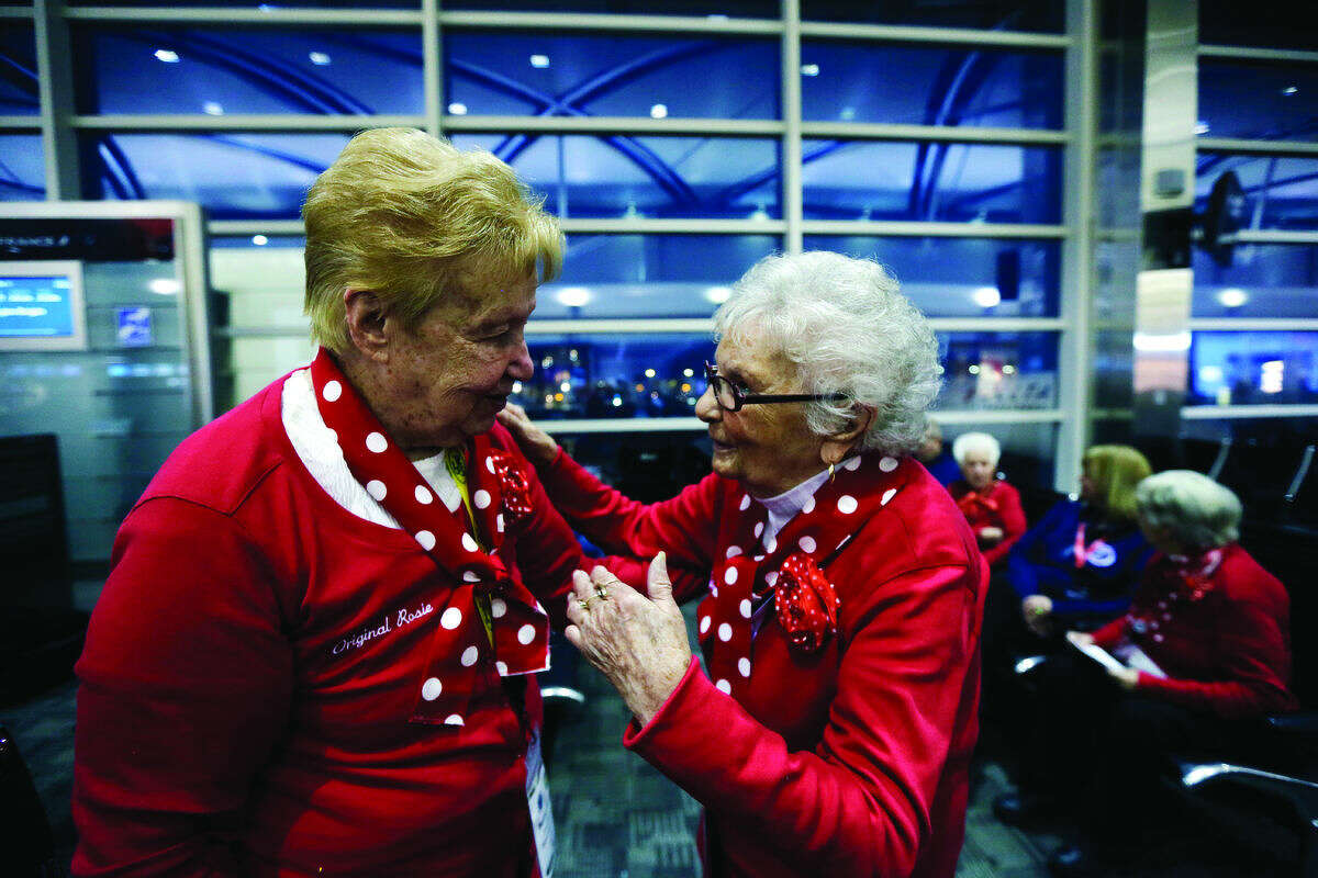 Former Rosies Betty Pazdro, left, talks with Mellie Mallon, before boarding a flight at Detroit Metropolitan Airport, Tuesday, March 22, 2016, in Romulus. (AP)