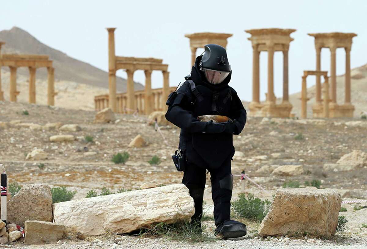 A Russian serviceman on April 8 checks for mines in the Palmyra ancient ruins, Syria. Russian combat engineers arrived in Syria on a mission to clear mines in the ancient town of Palmyra, which has been recaptured from Islamic State militants in an offensive that has proven RussiaÂ?’s military might in Syria despite a drawdown of its warplanes. (Russian Defense Ministry Press Service Photo via AP)