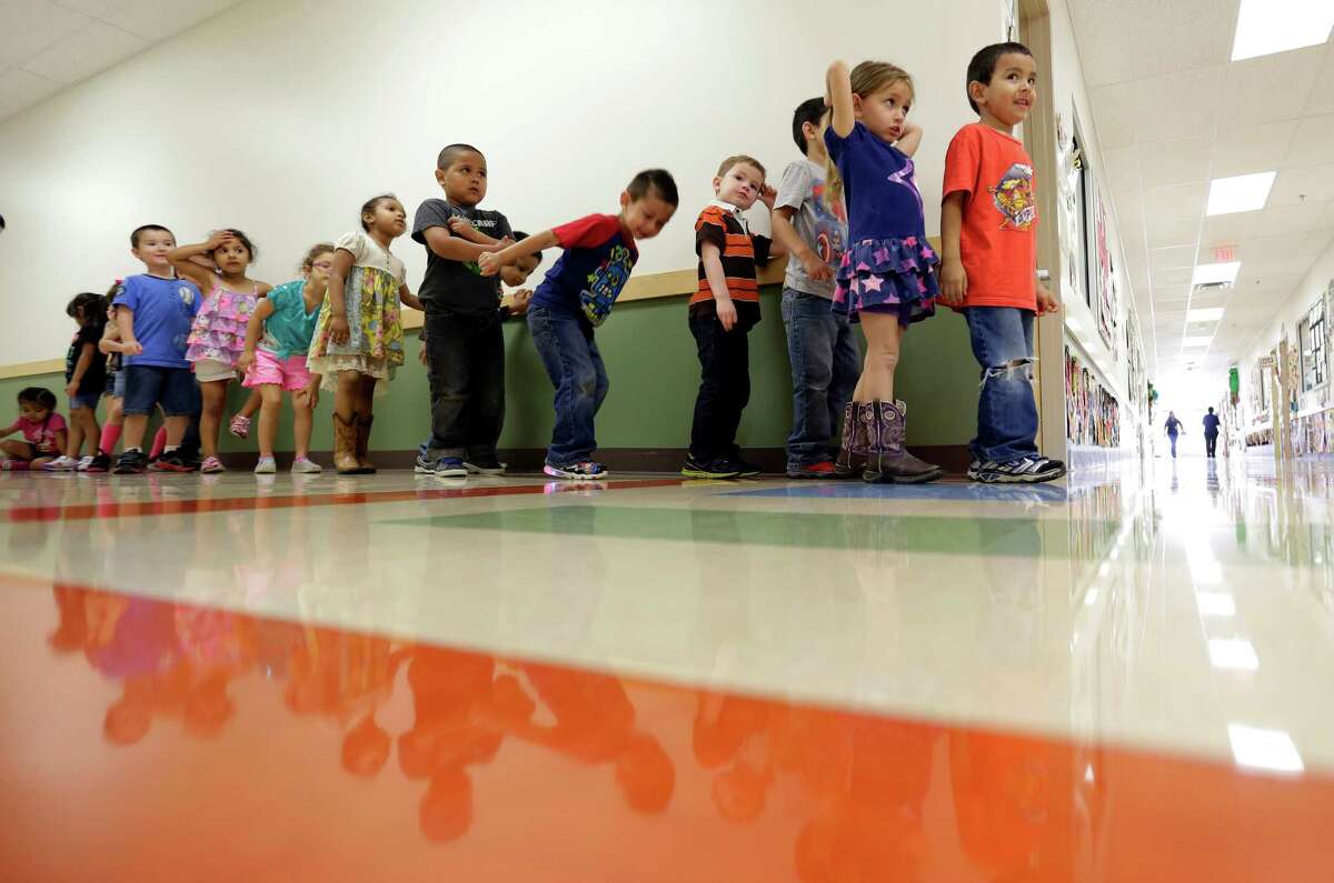 Pre-K students line up outside a classroom at the South Education Center in San Antonio. (AP Photo/Eric Gay)