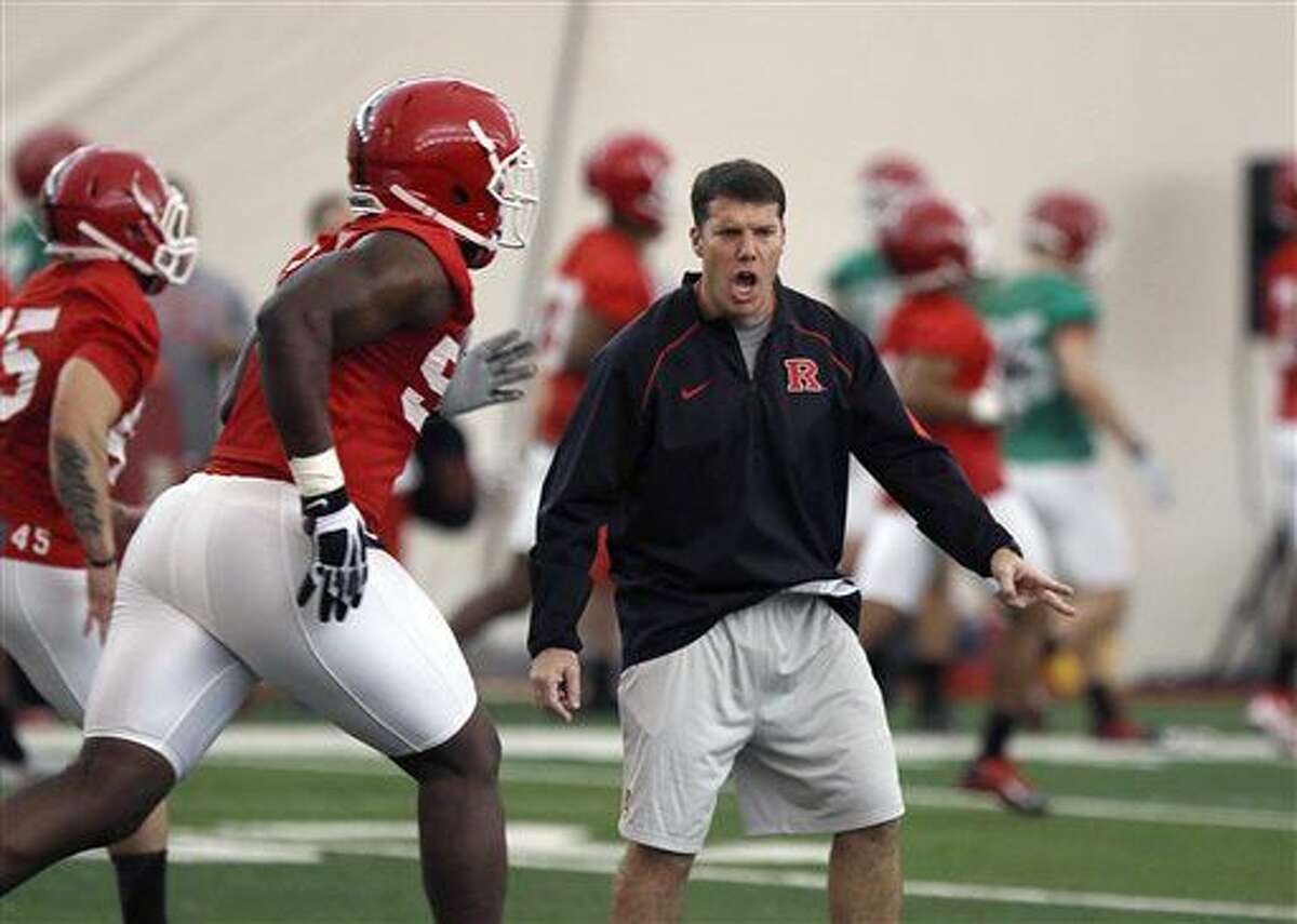Rutgers NCAA college football coach Chris Ash talks to players during a spring practice Thursday, March 24, 2016, in Piscataway, N.J. (Chris Pedota /The Record of Bergen County via AP) ONLINE OUT; MAGS OUT; TV OUT; INTERNET OUT; NO ARCHIVING; MANDATORY CREDIT