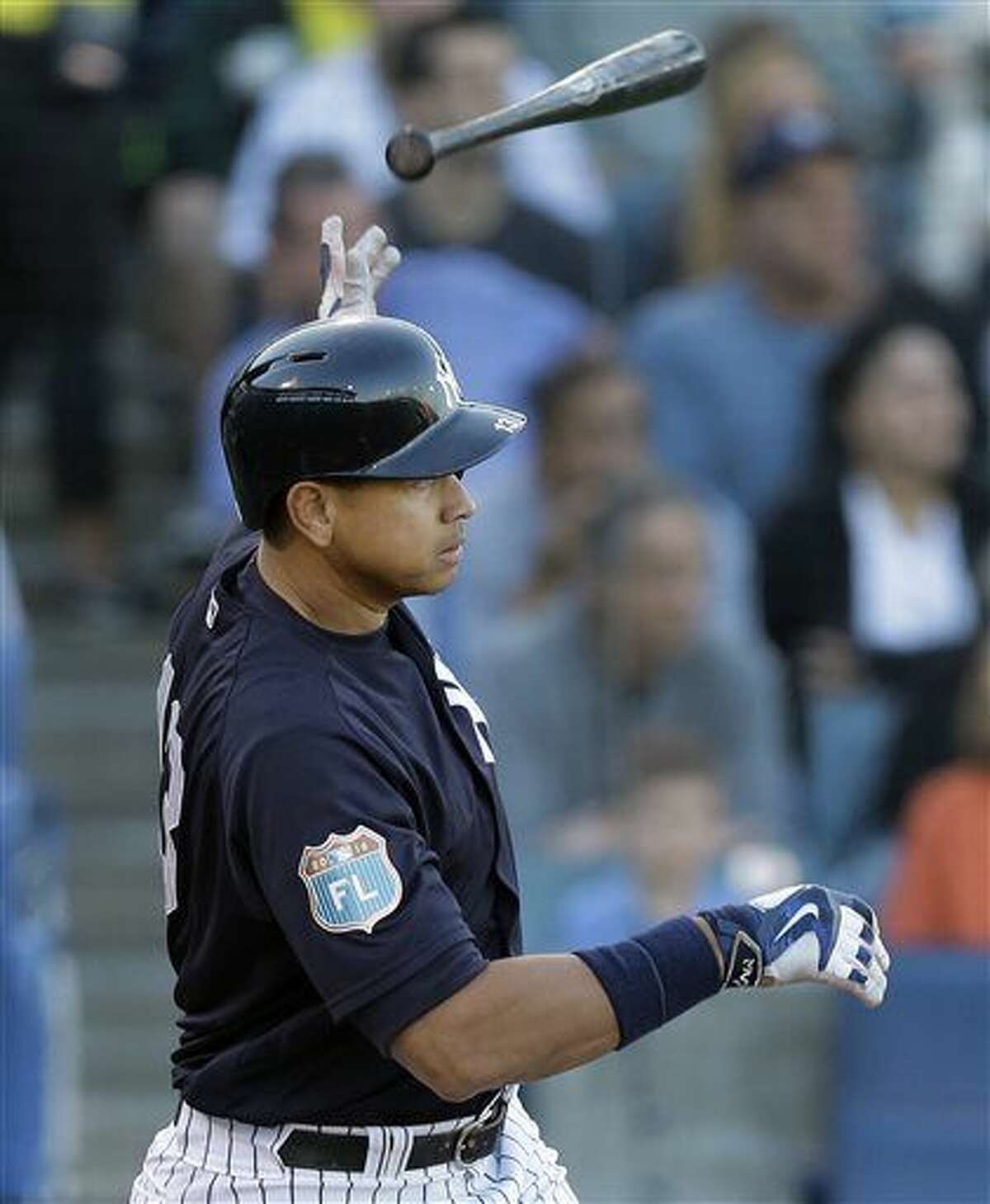 New York Yankees' Alex Rodriguez flips his bat as he watches his two-run single off New York Mets starting pitcher Steven Matz during the second inning of a spring training baseball game Tuesday, March 22, 2016, in Tampa, Fla. Yankees' Brett Gardner and Didi Gregorius both scored on the hit. (AP Photo/Chris O'Meara)