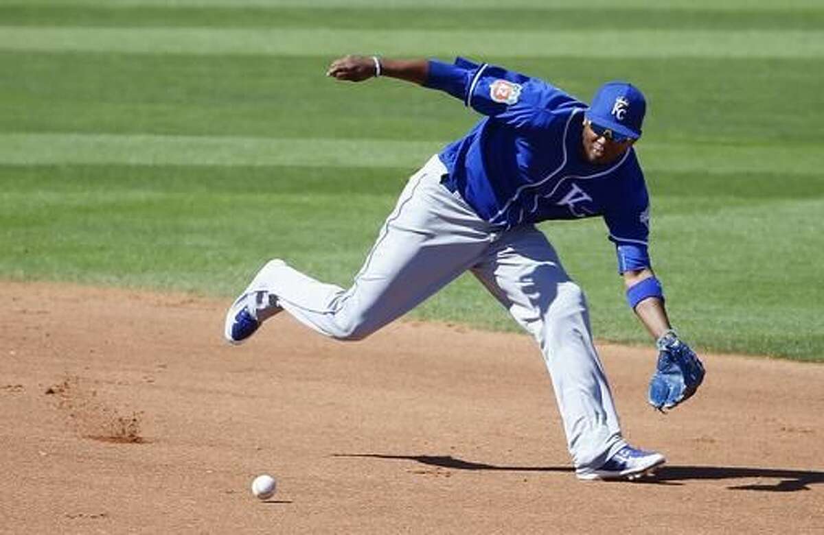 Kansas City Royals' Alcides Escobar runs down a grounder hit by Cleveland Indians' Francisco Lindor during the fourth inning of a spring training baseball game Wednesday, March 23, 2016, in Goodyear, Ariz. (AP Photo/Ross D. Franklin)