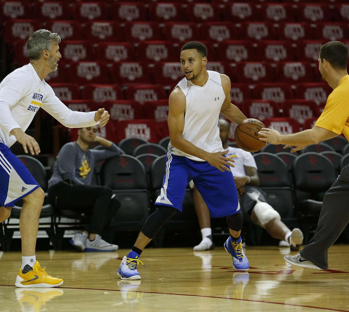 Golden State Warriors point guard Stephen Curry is double teamed by trainers as they practiced at Toyota Center, Wednesday, April 20, 2016, in Houston, as they prepared for Game 3 against the Houston Rockets in Round 1 of the playoffs. ( Karen Warren / Houston Chronicle )