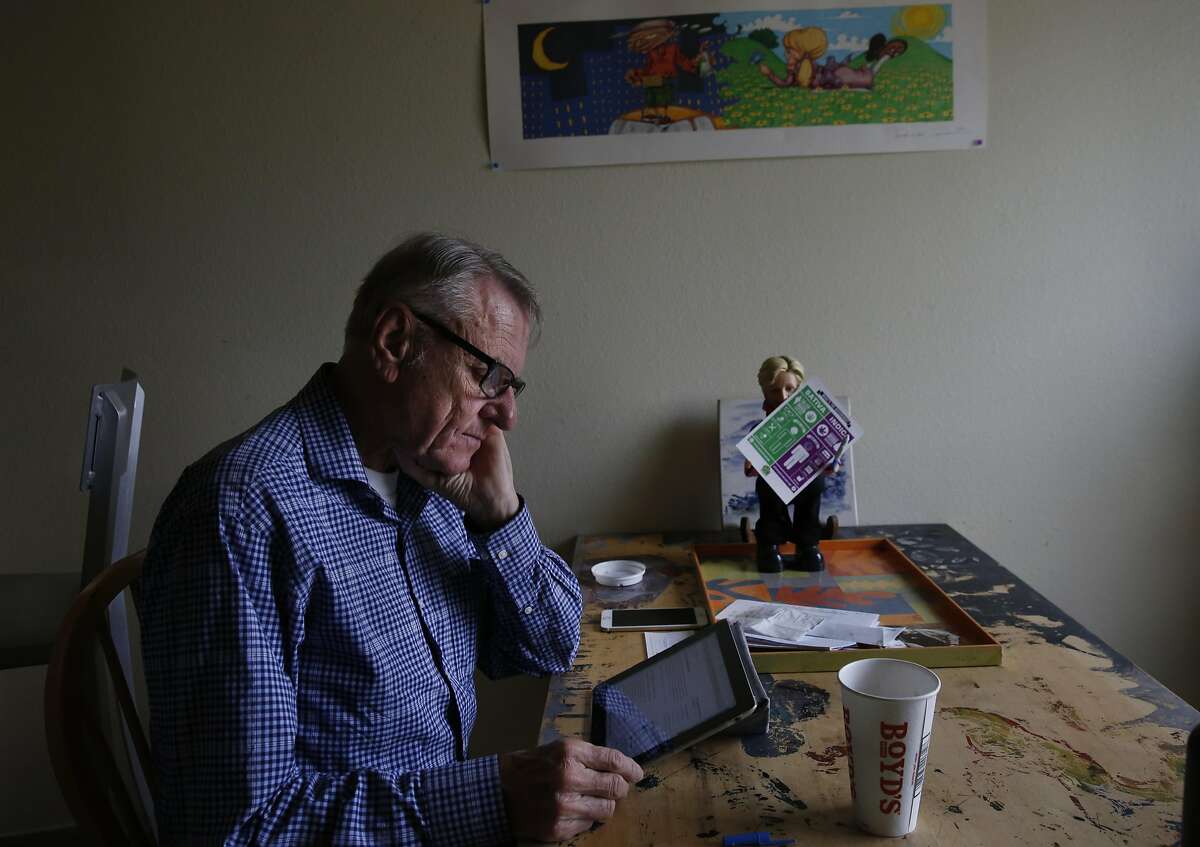 Dennis Coder, 75, looks up how to register a small business with the city so he can keep driving for Uber at his home on Treasure Island April 21, 2016 in San Francisco, Calif.