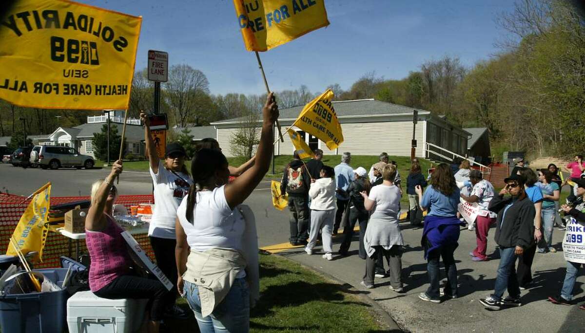 Striking healthcare workers picket, Thurs., April 15, 2010, outside the Birmingham Health Center in Derby.