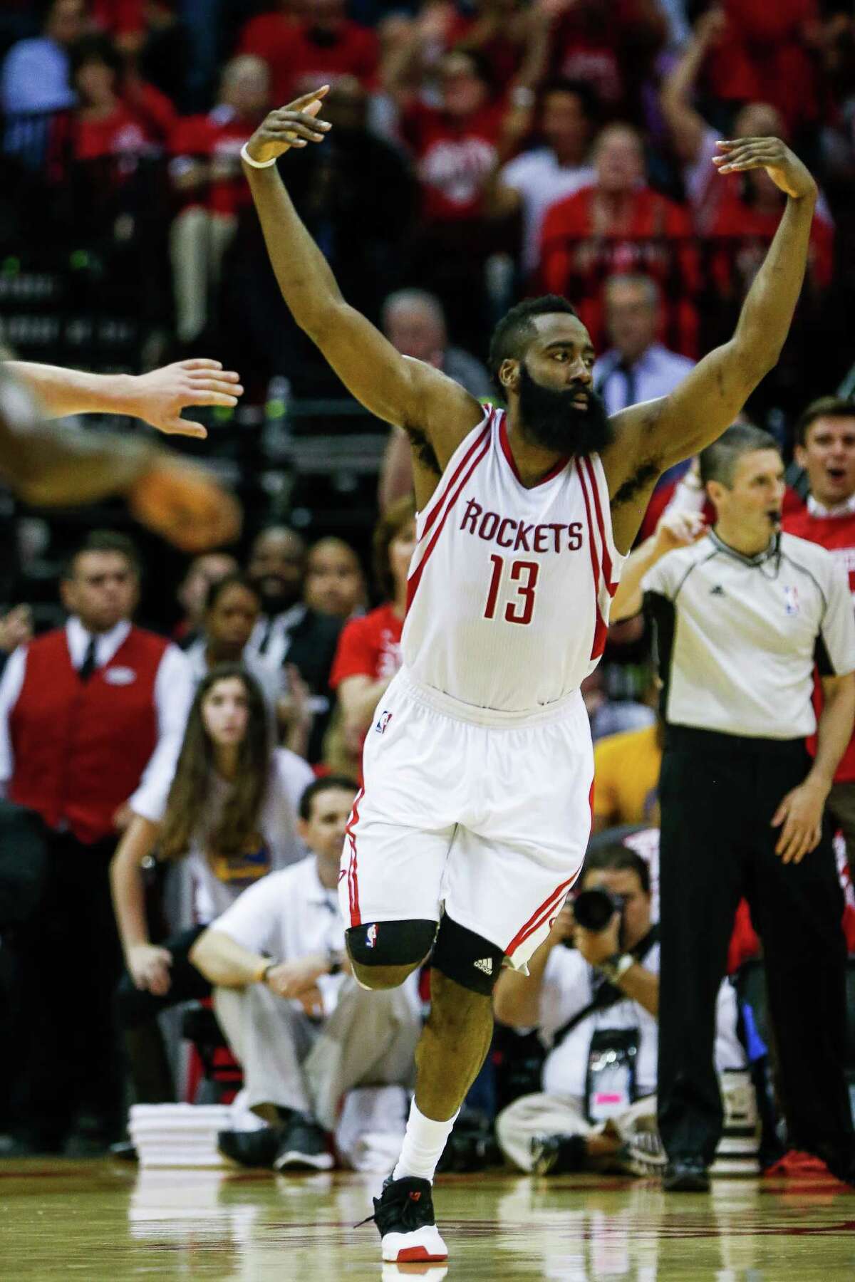 Houston Rockets guard James Harden (13) celebrates after a slam dunk against the Golden State Warriors during the second half in game three of a first-round NBA Playoffs series at Toyota Center Thursday, April 21, 2016 in Houston.