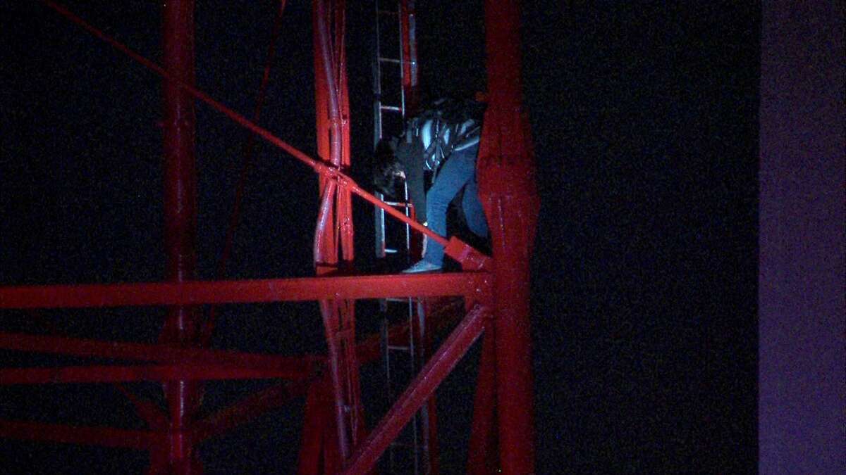 Police say they arrested three men who scaled a transmission tower early Friday morning downtown.