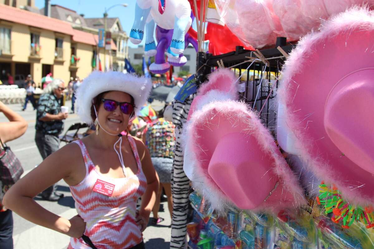 Vendors display their wares during the Battle of Flowers parade, Friday, April 22, 2016.