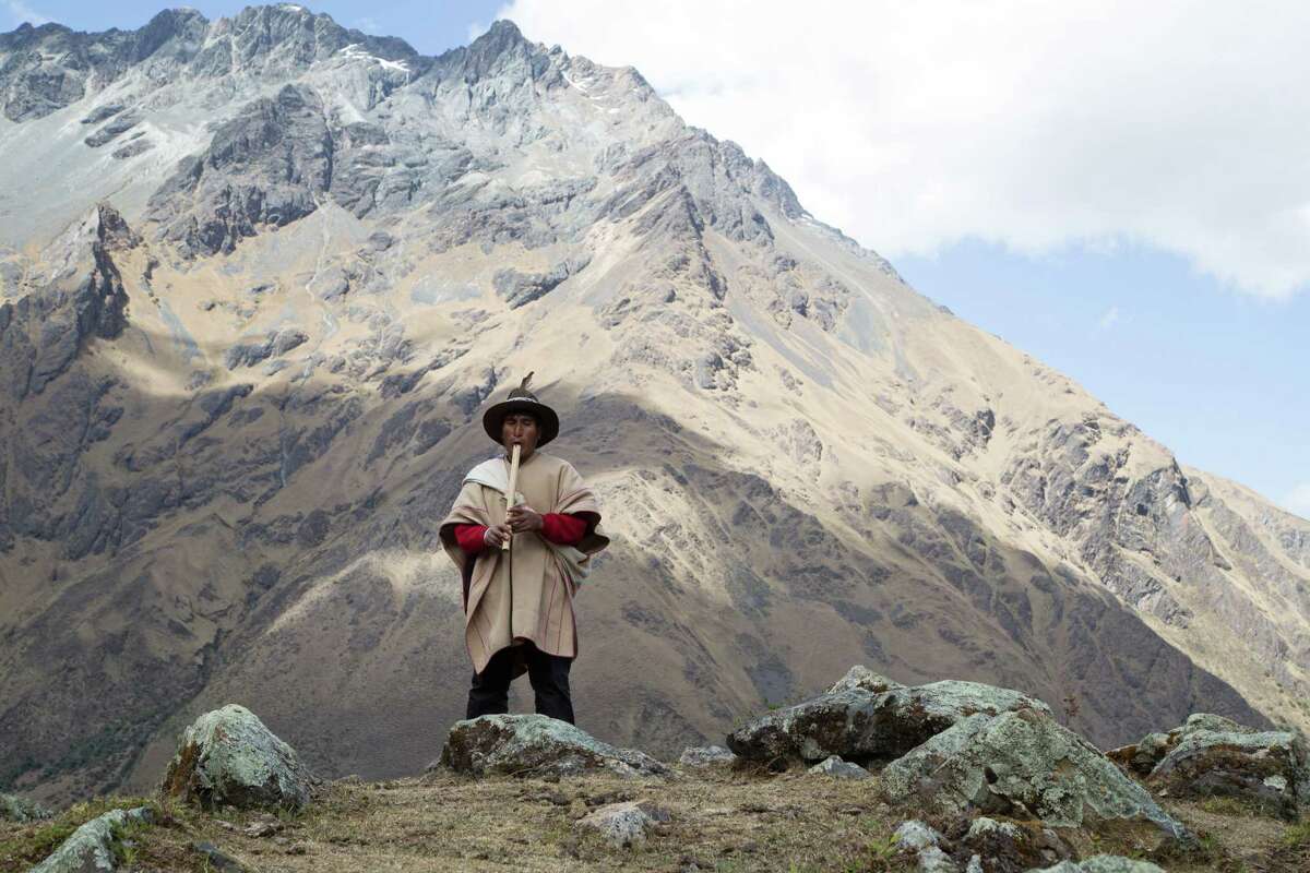 A man plays his Andean flute along the Salkantay Trail.
