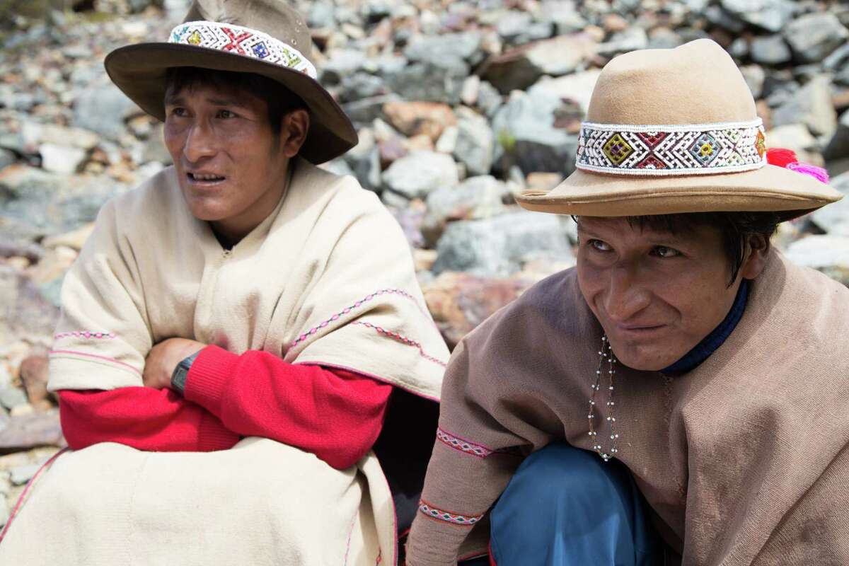 Quecha shaman Sebastian Qeras, right, rests during an acclimatization hike to the glacial Lake Humantay in Peru. He later performed a ritual offering to Pachamama and Apus, the mountain spirits.