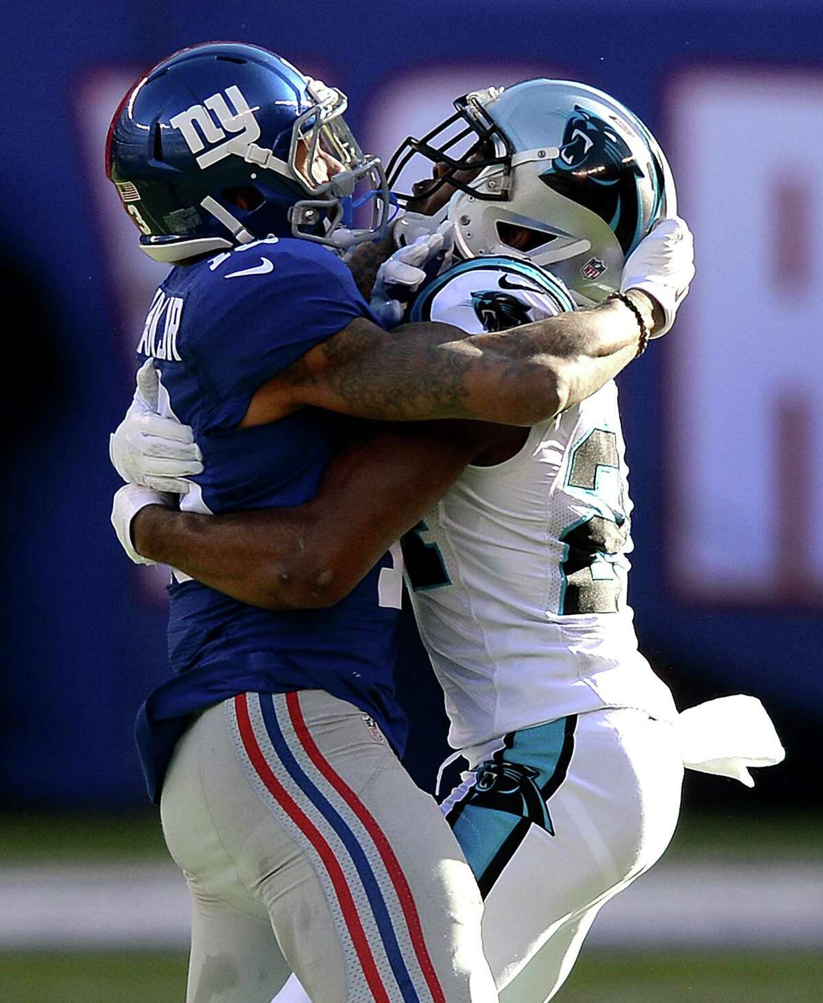 New York Giants wide receiver Odell Beckham Jr., left, and Carolina Panthers cornerback Josh Norman, right, wrap one another up during first-quarter action at MetLife Stadium in East Rutherford, N.J., on Sunday, Dec. 20, 2015. The Panthers won, 38-35. (Jeff Siner/Charlotte Observer/TNS)