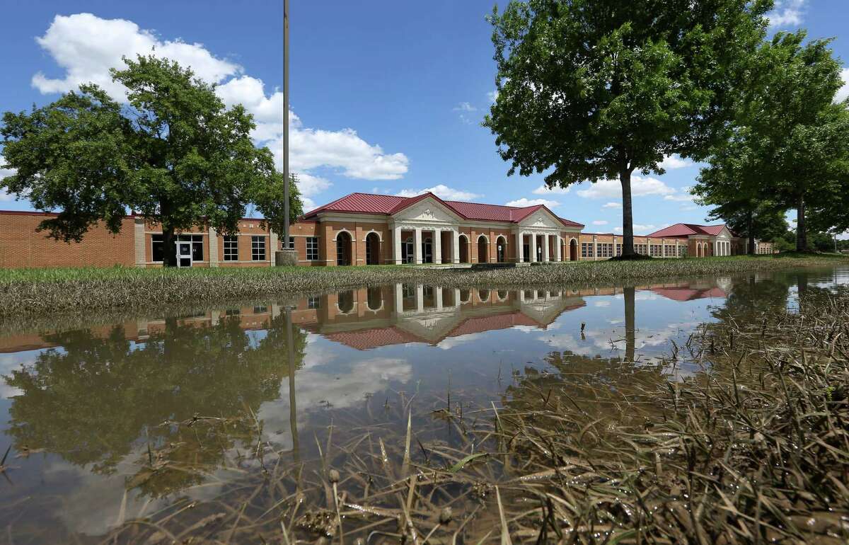 Cy-Fair High School still had pooled floodwater on Friday. Cy-Fair ISD saw 53 campuses damaged by the storm, but may only have to pay the $100,000 deductible if insurance approves the claims.﻿