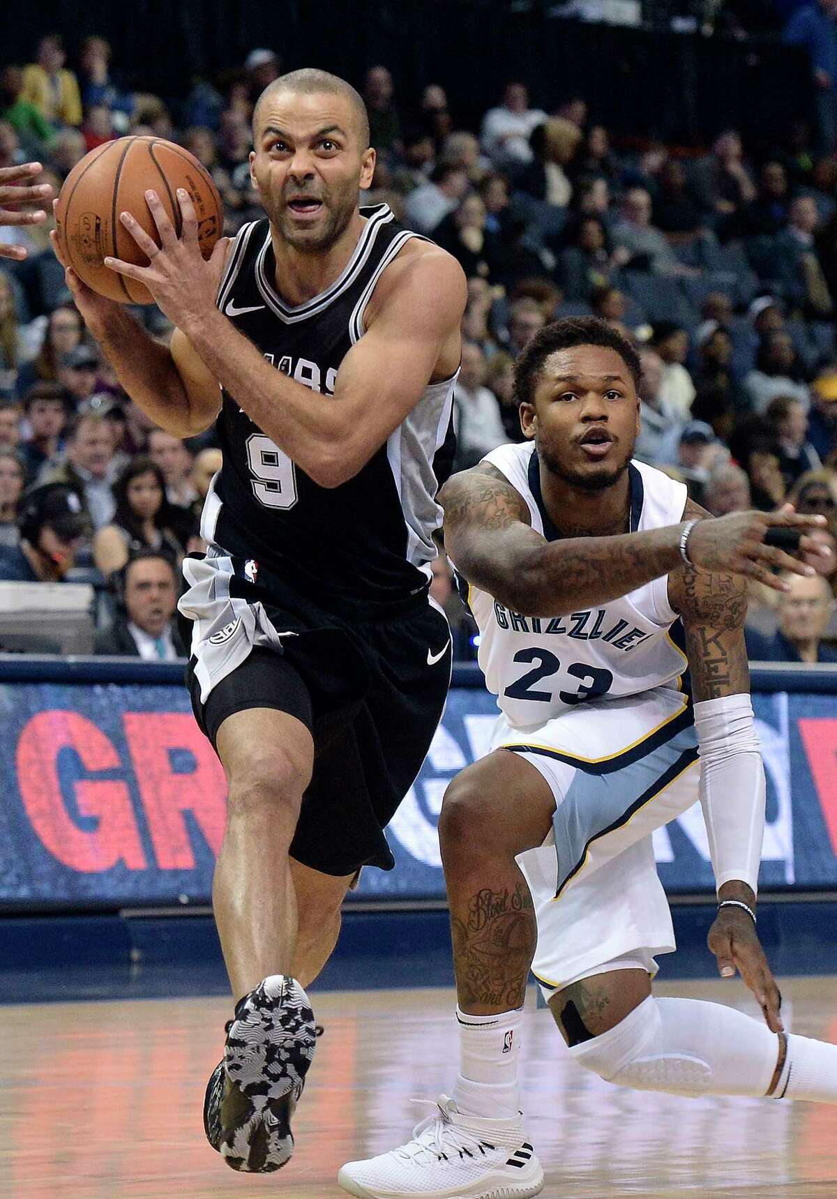 San Antonio Spurs guard Tony Parker (9) drives past Memphis Grizzlies guard Ben McLemore (23) during the second half of an NBA basketball game Wednesday, Jan. 24, 2018, in Memphis, Tenn. (AP Photo/Brandon Dill)