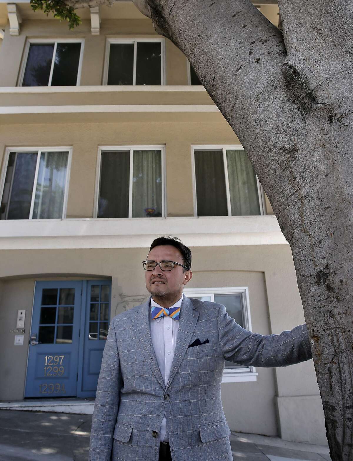 Supervisor David Campos stands in front of a Mission District property which was cited by the city in February for illegal conversion to tourist use. Campos and other supervisors are now revising a law to strengthen enforcement of hosting services in the face of a legal challenge by Airbnb.