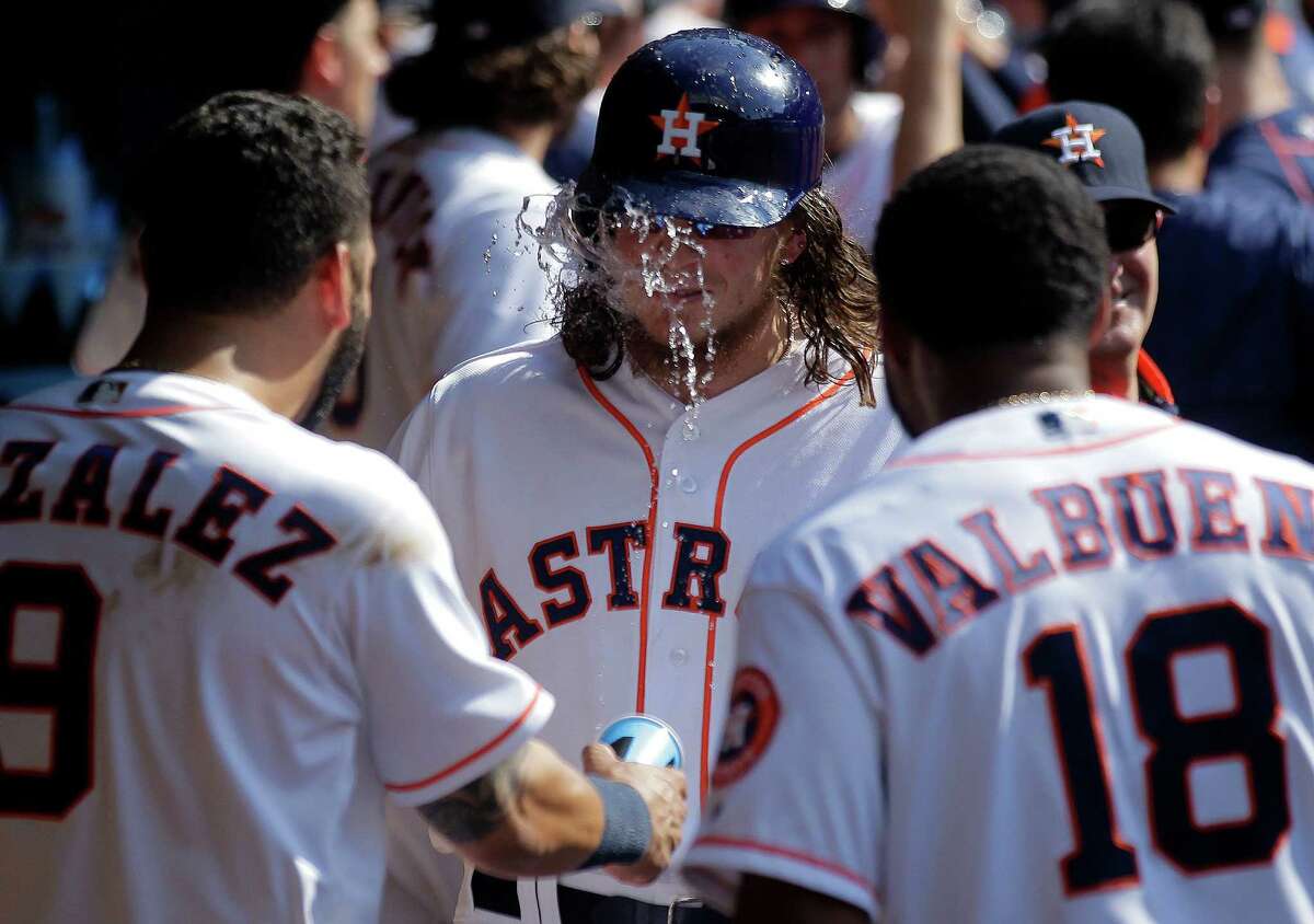 Houston Astros left fielder Colby Rasmus (28) gets water in his face by Houston Astros first baseman Marwin Gonzalez (9) after hitting a grand slam home run in the bottom of the fifth inning. Houston Astros game against the Boston Red Sox on Saturday, April 23, 2016, in Houston.