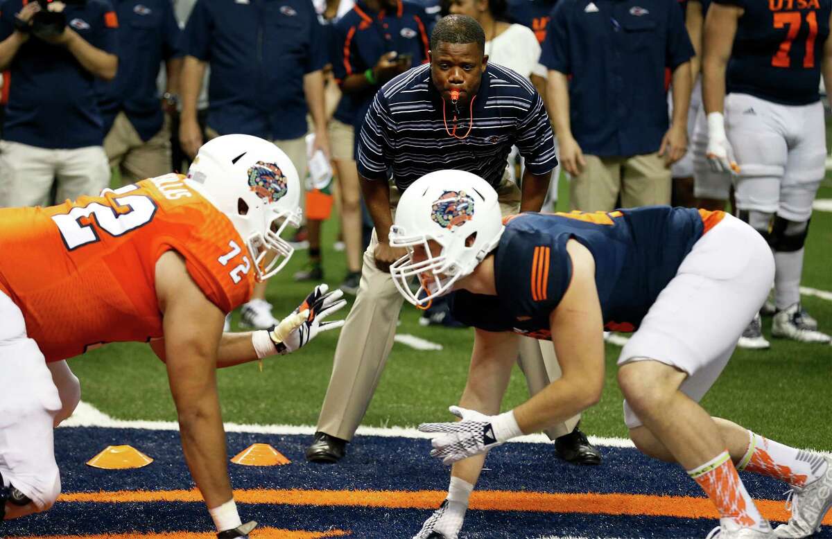 Coach Frank Wilson (top) focuses on linemen Gabriel Casillas (left) and defensive end Ben Kane (right) during before the UTSA spring game at the Alamodome on April 23, 2016.