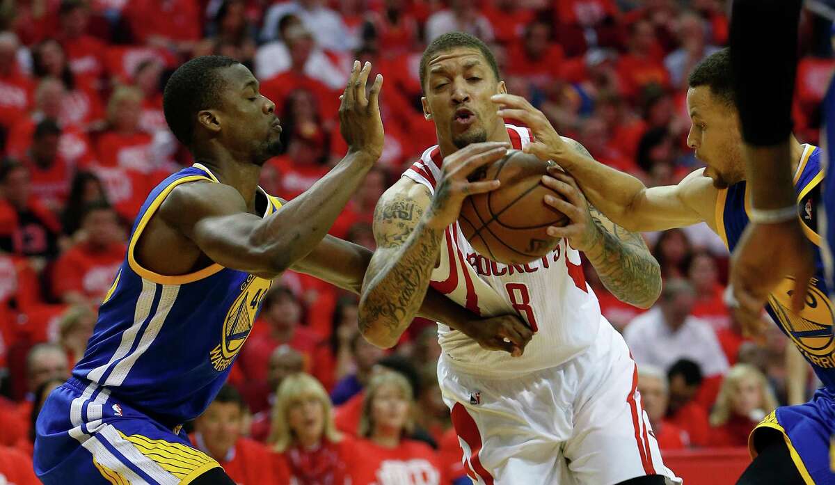 Houston Rockets forward Michael Beasley (8) tries to make it to the basket against Golden State Warriors forward Harrison Barnes (40) and guard Stephen Curry (30) during the first half of game four of the first round of the NBA playoff series at Toyota Center, Sunday, April 24, 2016, in Houston.
