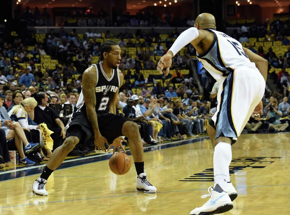 MEMPHIS, TN - APRIL 24: Kawhi Leonard #2 of the San Antonio Spurs dribbles against Vince Carter #15 of the Memphis Grizzlies during the first half of Game Four of the First Round of the NBA Playoffs at FedExForum on April 24, 2016 in Memphis, Tennessee. NOTE TO USER: User expressly acknowledges and agrees that, by downloading and or using this photograph, User is consenting to the terms and conditions of the Getty Images License Agreement. (Photo by Frederick Breedon/Getty Images)