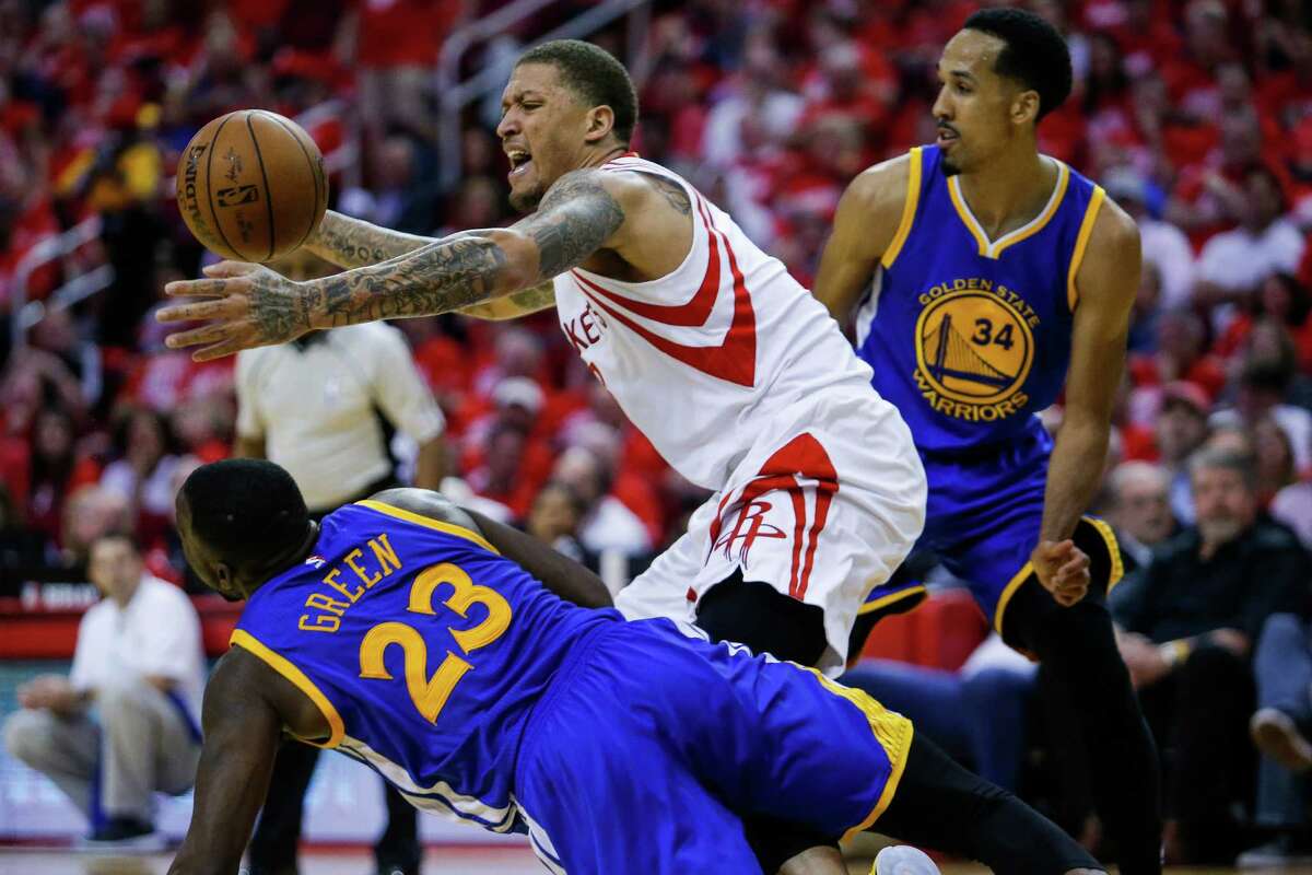 Houston Rockets forward Michael Beasley (8) reaches for a loose ball as Golden State Warriors forward Draymond Green (23) makes a dive for it during the second half in game four of a first-round NBA Playoffs series at Toyota Center Sunday, April 24, 2016 in Houston.
