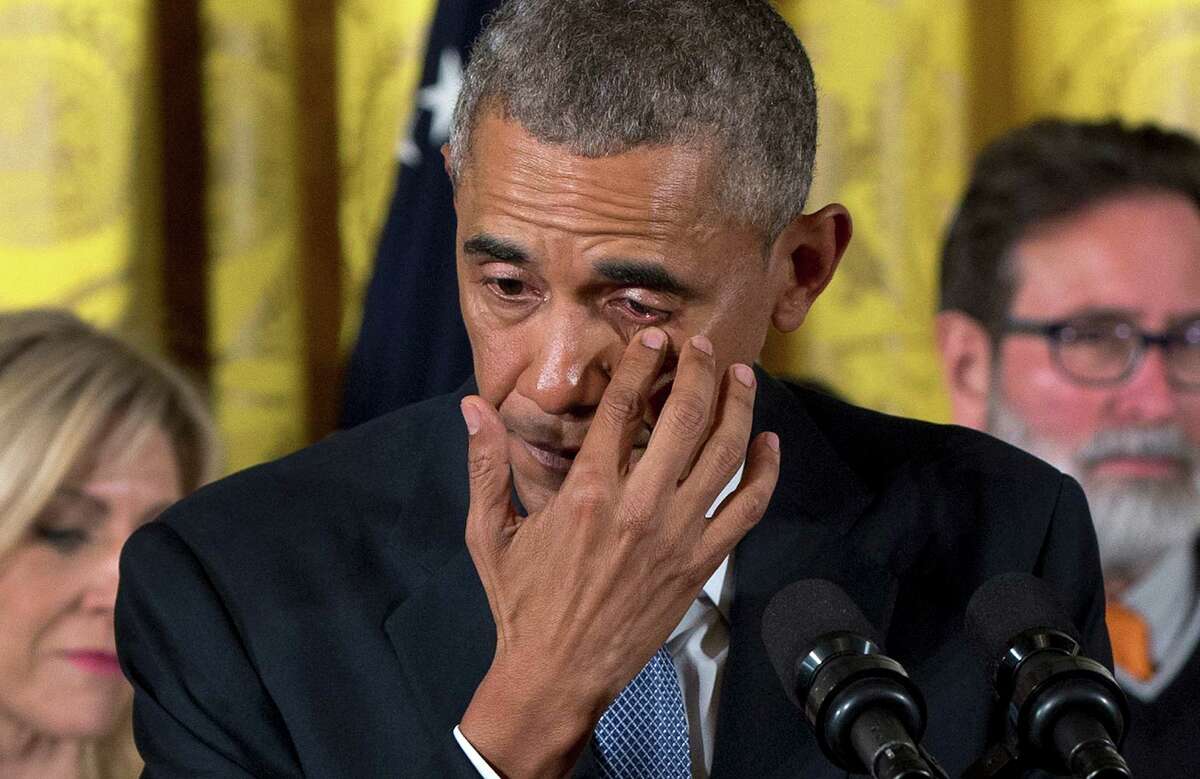 President Barack Obama wipes tears from his eyes as he speaks in the East Room of the White House in Washington, Tuesday, Jan. 5, 2016, about steps his administration is taking to reduce gun violence. Also on stage are stakeholders, and individuals whose lives have been impacted by the gun violence. (AP Photo/Carolyn Kaster) ORG XMIT: DCCK105