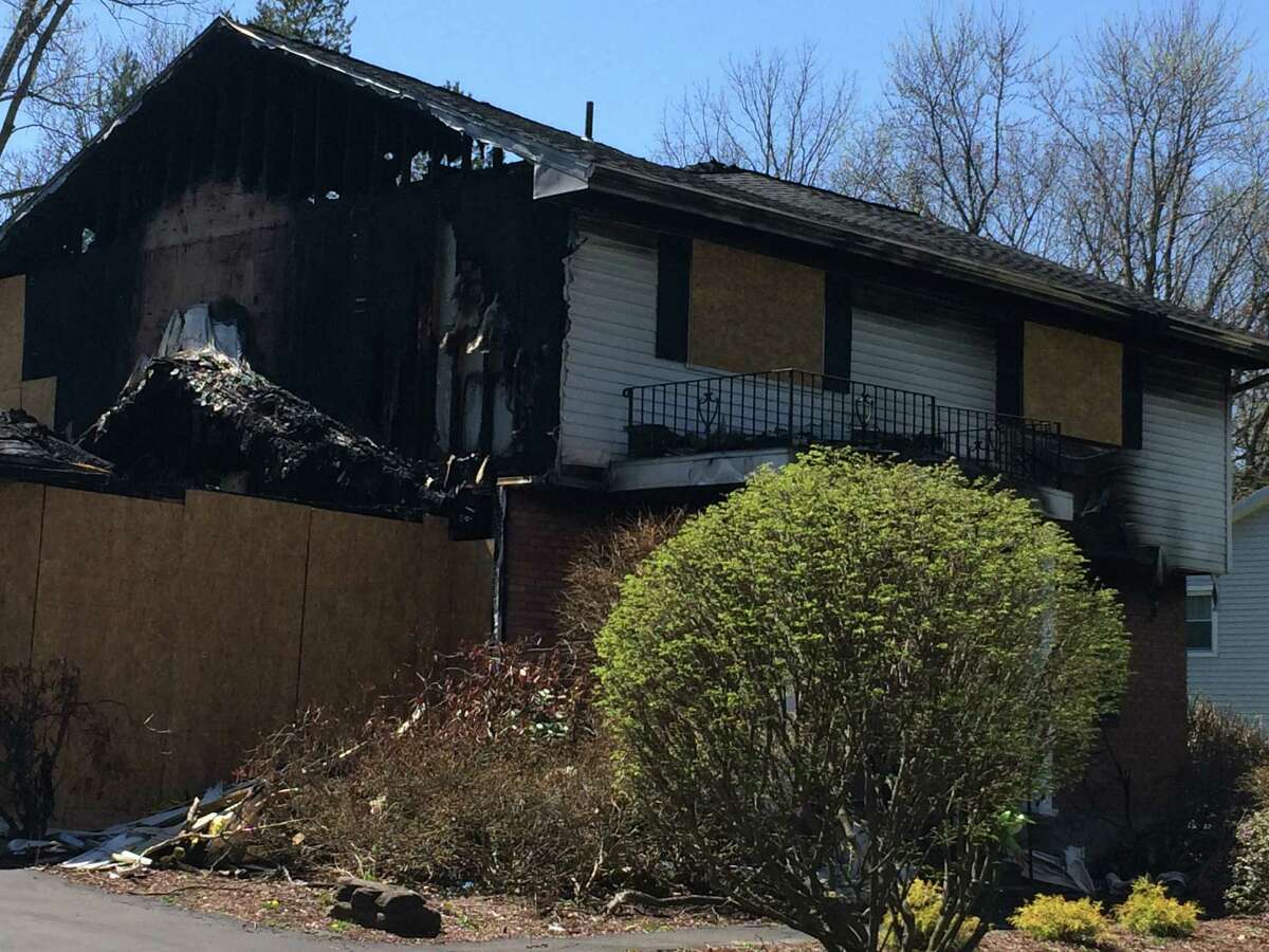 The home of Colonie police officer Israel Roman and his wife Deborah on Schalren Drive as seen on April 24, 2016. In Feb. 2016, police said Roman shot and killed his wife and 10-year-old son before setting his house on fire and killing himself. The house still sits as it did that February day, with a posting from the Town of Colonie saying it is an unsafe condition. (Lauren Stanforth/Times Union)