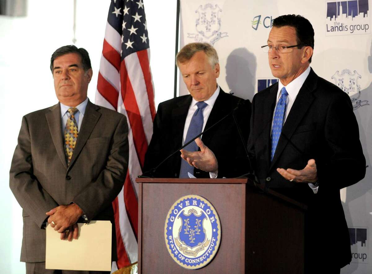 Charter Communications CEO Tom Rutledge, center, listens to Gov. Dannel P. Malloy in October 2012 alongside then-Mayor Mike Pavia at what would become the company’s headquarters at 400 Atlantic Street in Stamford, Conn.