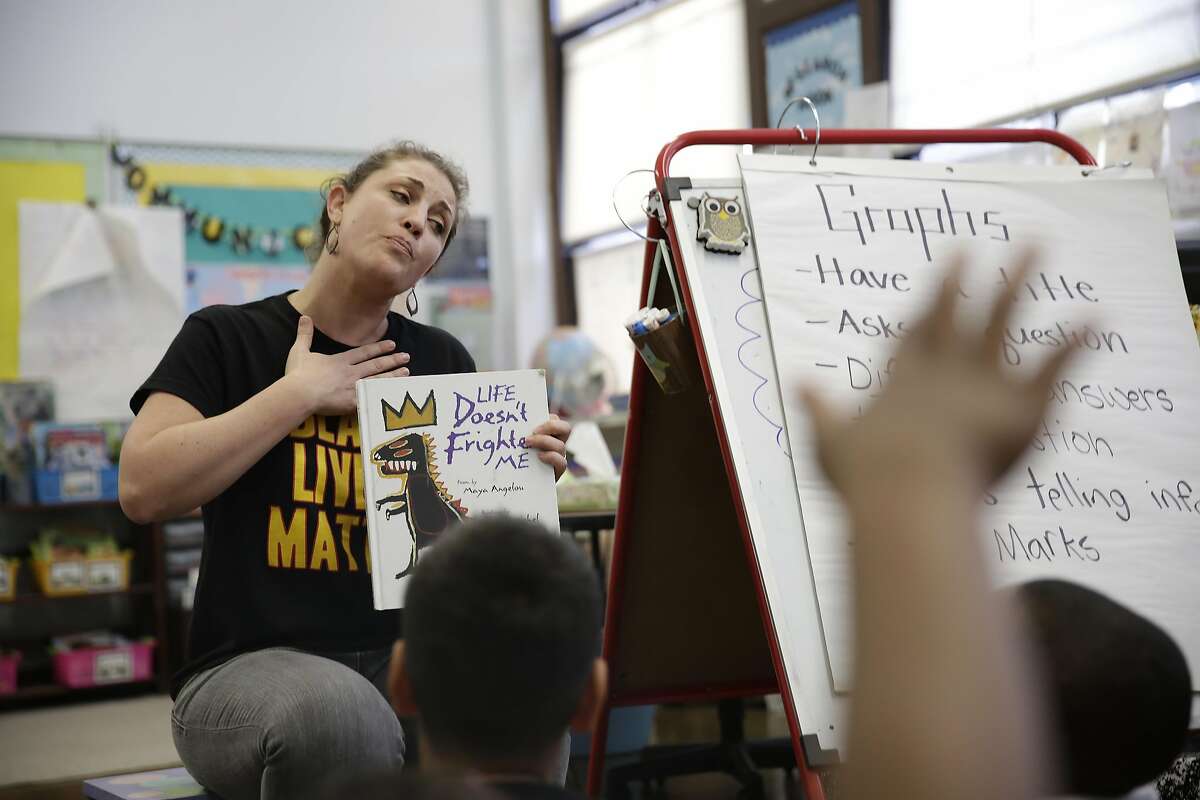 Jessica Black, second grade teacher Rosa Parks Elementary School, reads to her students during class on Friday, April 8, 2016 in San Francisco, California.