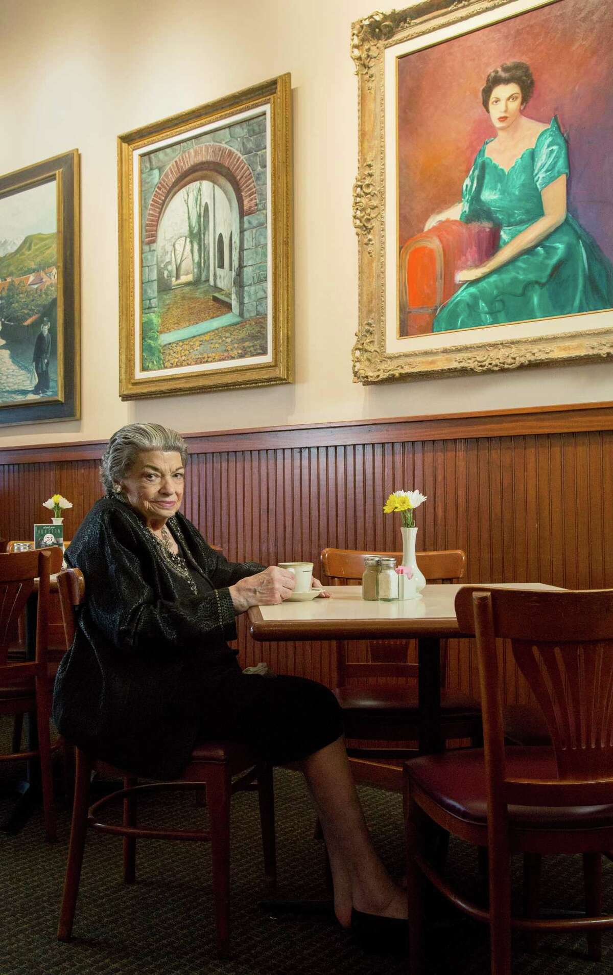 Pat Mickelis at Cleburne Cafeteria. Artwork on the walls of her restaurant were painted by her late husband, Nick.