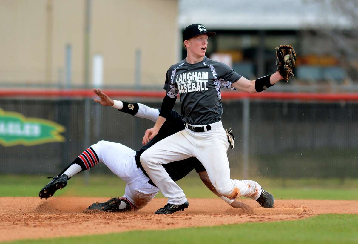 Langham Creek 2nd baseman John Michael Sopher makes a play against Fort Bend Austin baserunner Charles Robinson during their scrimmage at LCHS on Feb. 21.