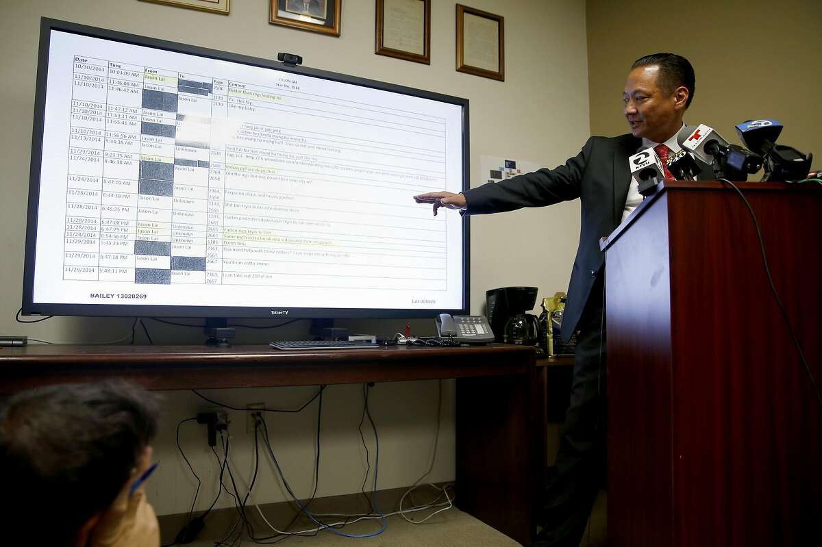 Public Defender Jeff Adachi gestures to particular text messages on a television screen while speaking to journalists about recently uncovered racist text messages sent by San Francisco Police Officer Jason Lai during a press conference in San Francisco, California, on Tuesday, April 26, 2016.