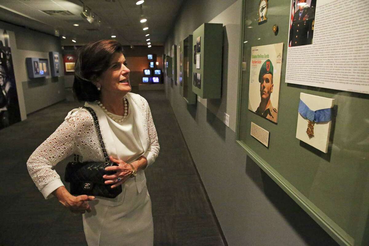 Luci Baines Johnson looks at displays in the Vietnam War exhibit at the Vietnam War Summit hosted by the LBJ Presidential Library on April 26, 2016.