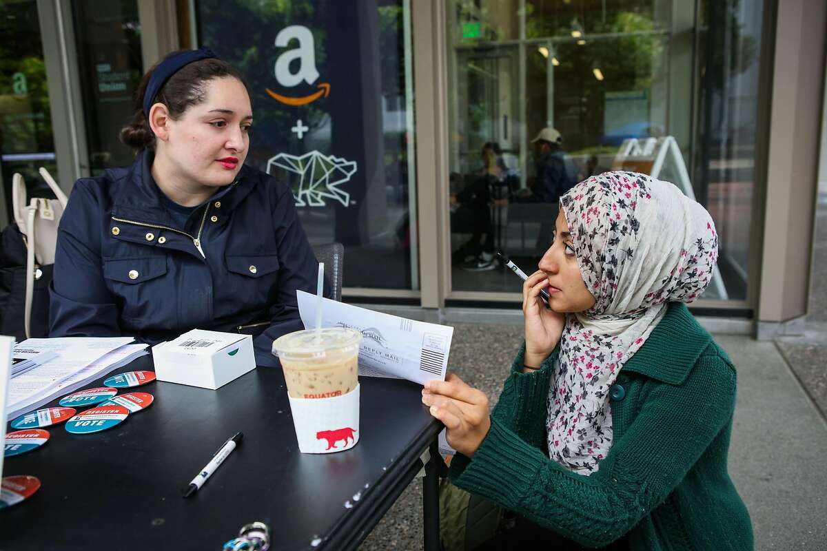 Hanin Benchohra, 21, (right) gets help from student Sarah Funes, 24 as she fills out a voter registration form, at UC Berkeley, in Berkeley, California, on Wednesday, April 27, 2016. Hanin is voting for the first time in her life.