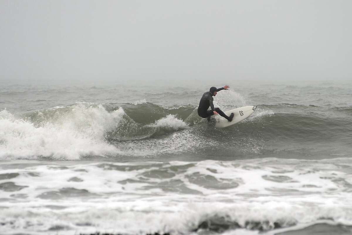 Surfers are seen enjoying the waves at Martin's Beach in Half Moon Bay Tuesday March 12th, 2013.