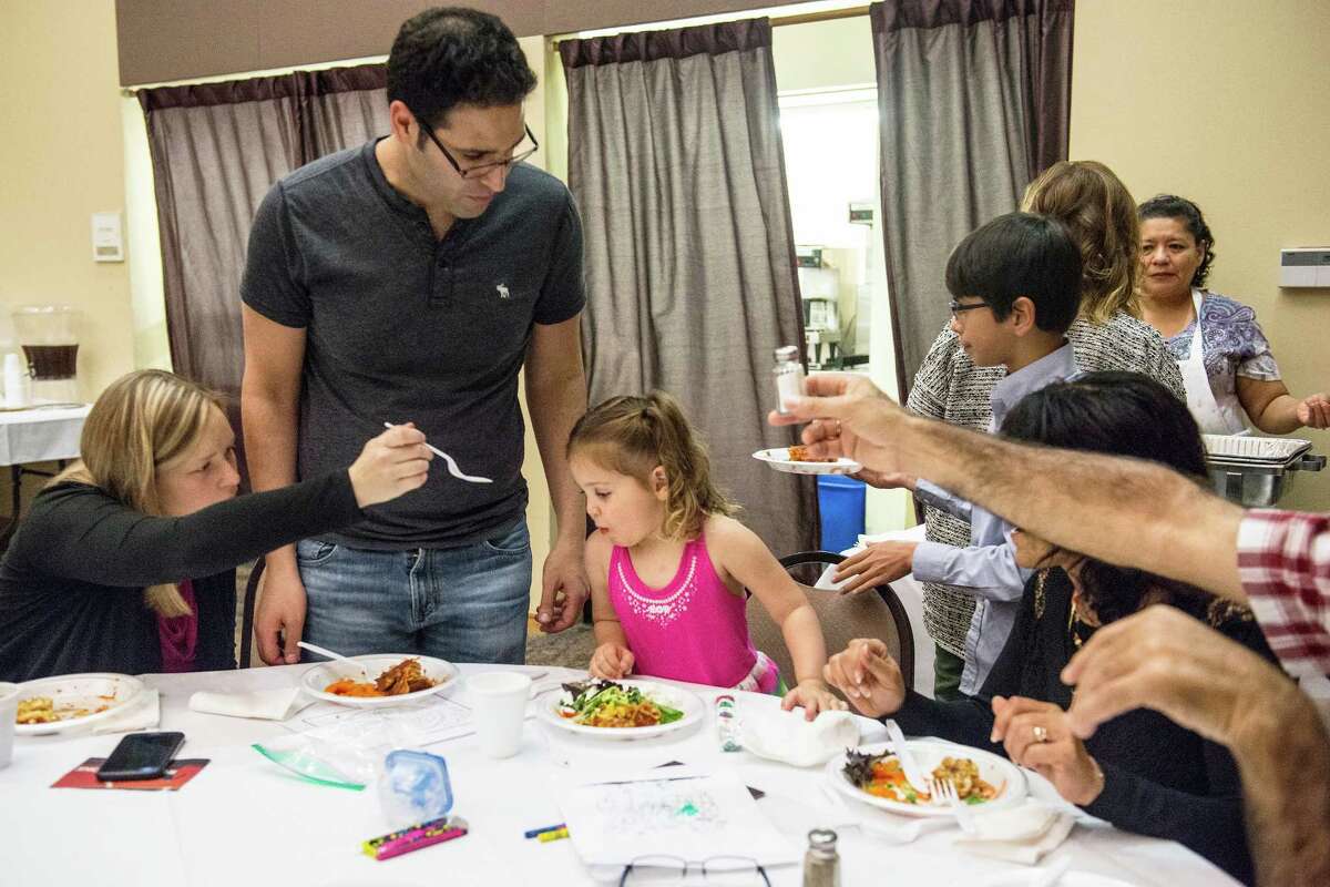 From left, Rebecca Raphael, husband Itay Raphael, daughter Noa Raphael, 3, mother-in-law Drorit Raphael and father-in-law Yehiel Raphael, enjoy a Passover meal of Matzah lasagna at Barshop Jewish Community Center of San Antonio on Wednesday, April 27, 2016. The Raphael's parents are visiting their son and his family after the birth of Itay and Rebecca's son Adam (not pictured here). The center put on the meal as a way of supporting their community during the stricter dietary days of Passover.