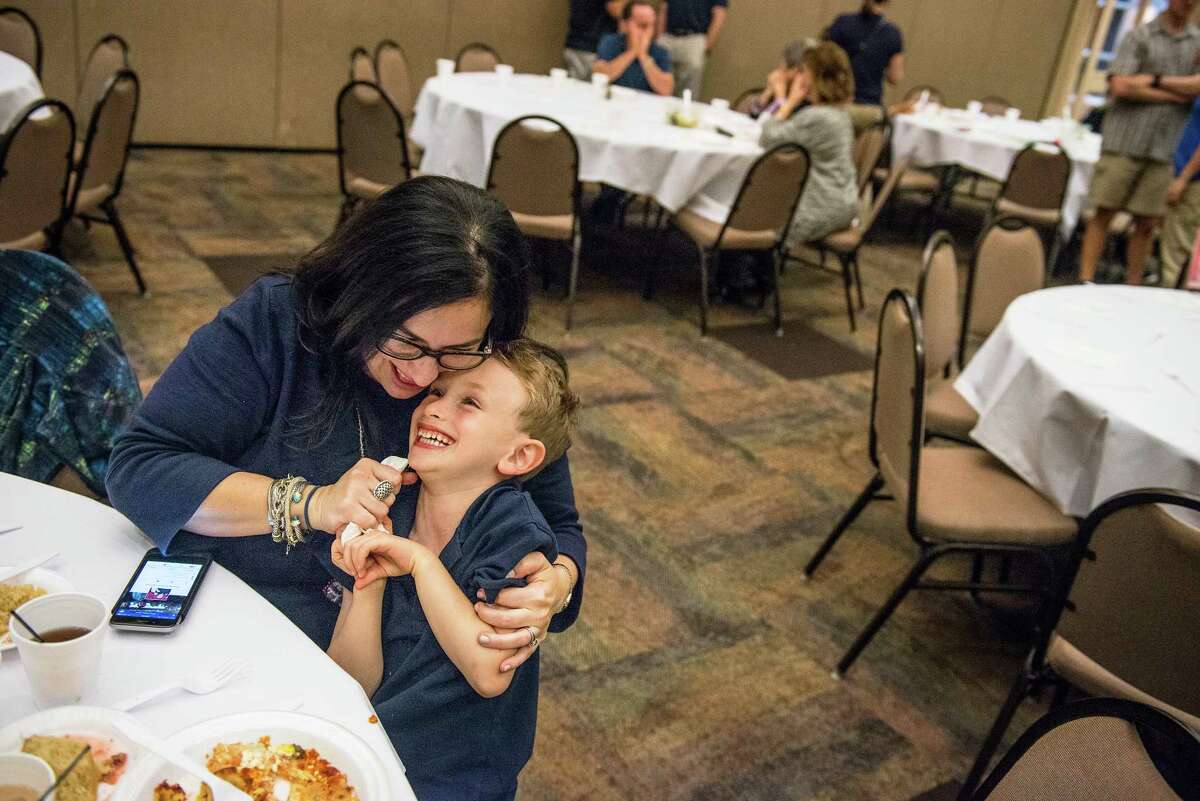 Lauren Abraham plays with her son Benny Abraham, 5, during a Passover meal of Matzah lasagna at Barshop Jewish Community Center of San Antonio on Wednesday, April 27, 2016. The center put on the meal as a way of supporting their community during the stricter dietary days of Passover.