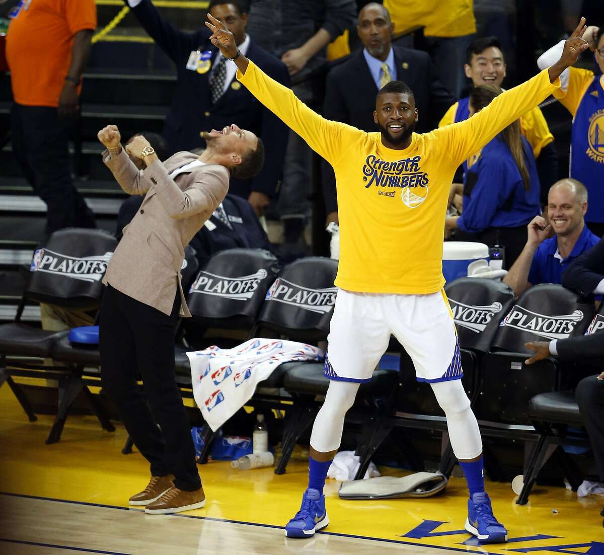 Golden State Warriors' Stephen Curry and Festus Ezeli enjoy a Klay Thompson 3-pointer in 3rd quarter against Houston Rockets in Game 5 of 1st Round of NBA Playoffs at Oracle Arena in Oakland, Calif., on Wednesday, April 27, 2016.