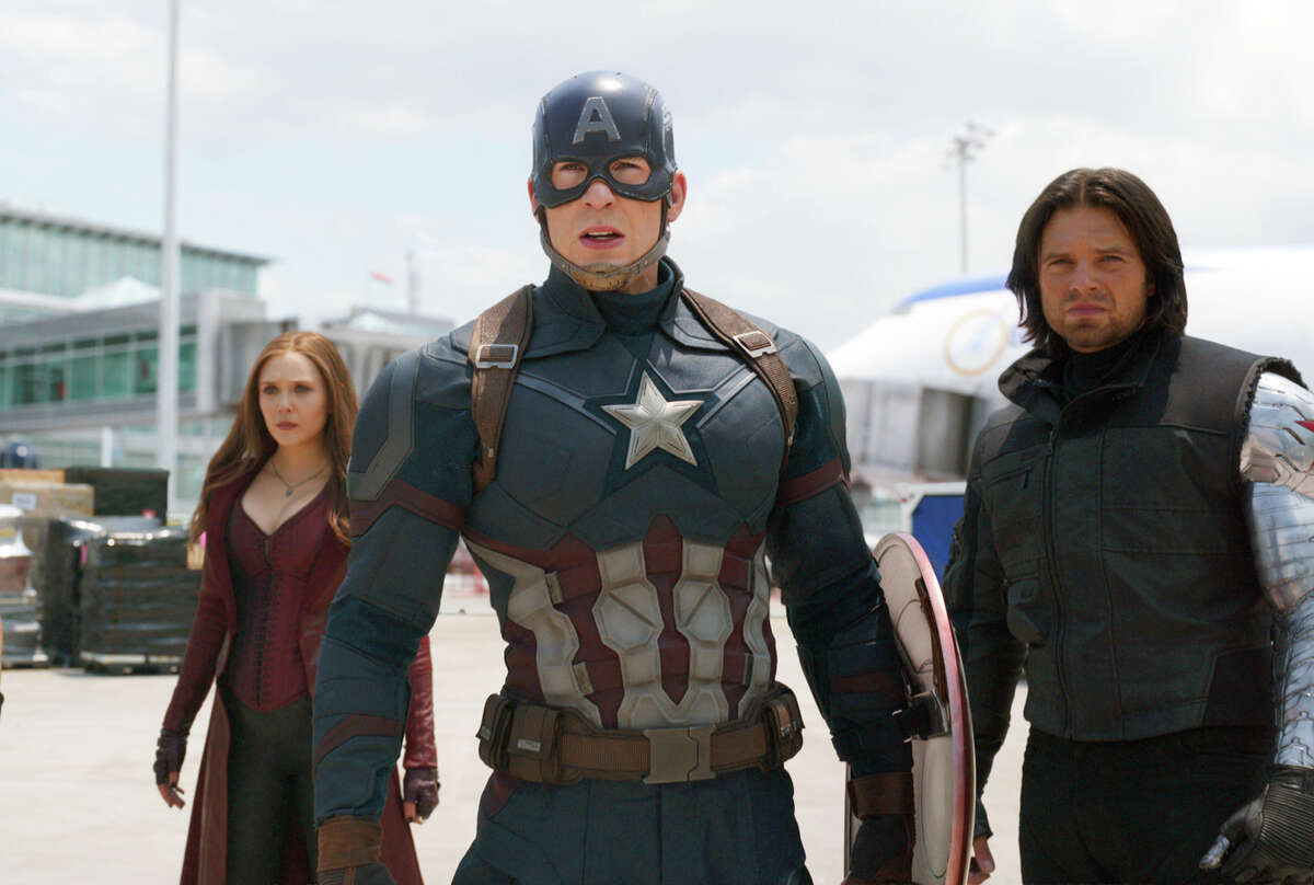 This image released by Disney shows Elizabeth Olsen, left, Chris Evans and Sebastian Stan in a scene from Marvel's "Captain America: Civil War," opening in theaters nationwide on May 6, 2016. (Disney/Marvel via AP)