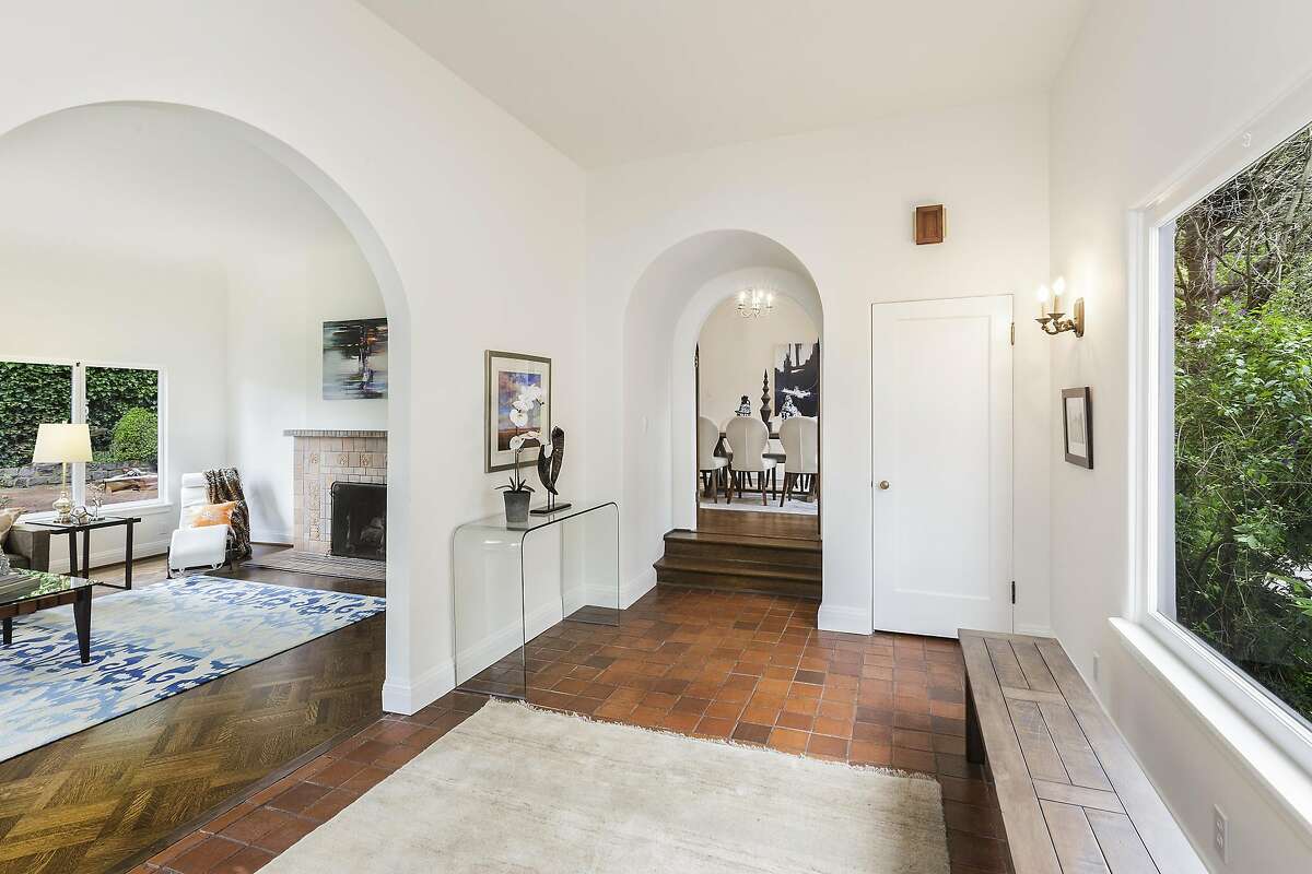 The storybook home's tile entry features arches and a sizable picture window.