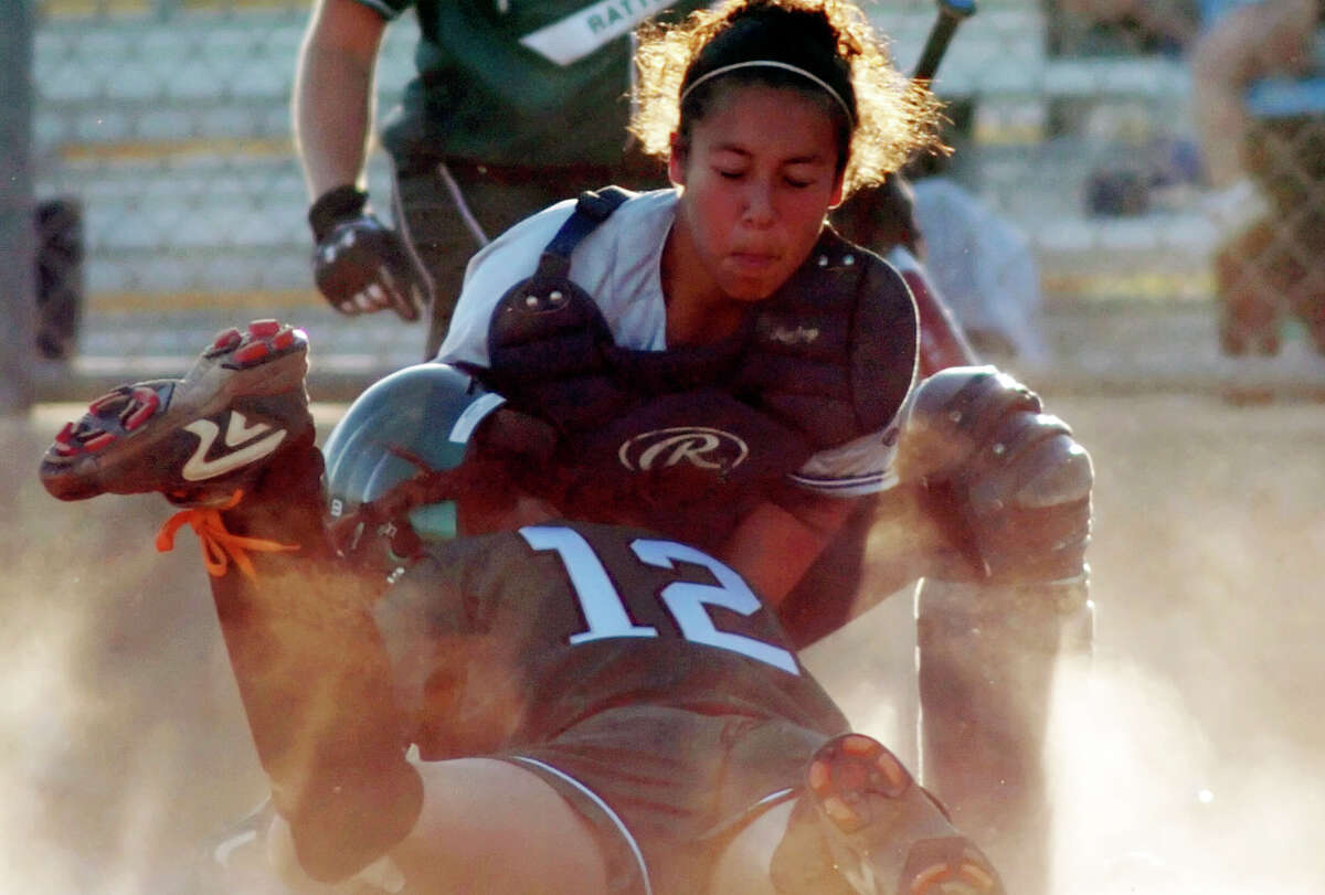 Reagan pinch runner Jean Rodriguez (12) is tagged out at home by Smithson Valley catcher Nikki Salazar on April 12, 2005 at North East Softball Complex.