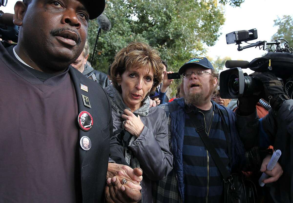 UC Davis Chancellor Linda Katehi (C) is escorted to a car after she spoke to Occupy protestors during a demonstration at the UC Davis campus on November 21, 2011 in Davis, California. Thousands of Occupy protestors staged a demonstration on the UC Davis campus to protest the UC Davis police who pepper sprayed students who sat passively with their arms locked during an Occupy Wall Street demonstration on November 18.