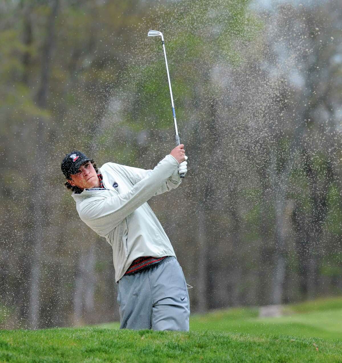 Justin Clark of New Canaan High School blasts out of a sand-trap onto the first green during the 2016 Brunswick Invitational Golf Tournament at the Round Hill Club in Greenwich, Conn., Thursday, April 28, 2016.