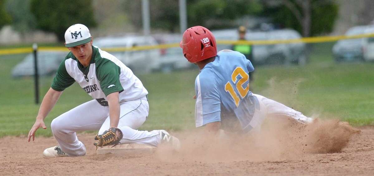 Kolbe's Chris Mojica (12) slides safely into second as New Milford's Timothy Gesauldi (5) turns to make the tag in the boys baseball game between Kolbe Cathedral and New Milford high schools, on Friday, April29, 2016, at New Milford High School, New Milford, Conn.