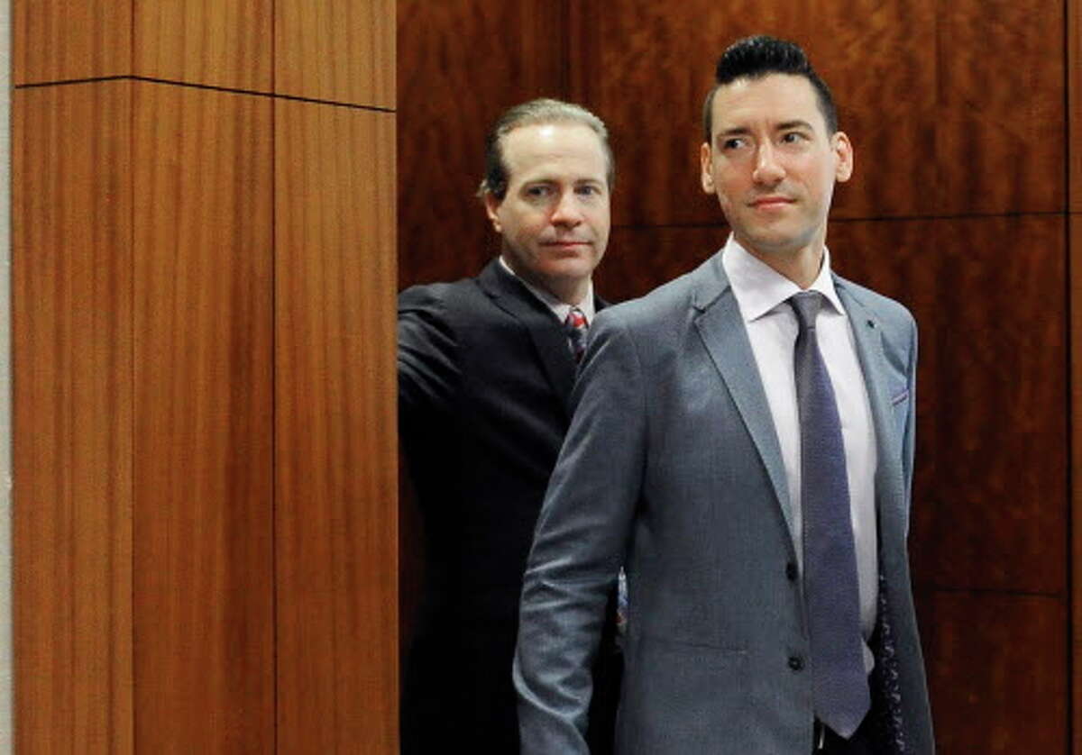 David Robert Daleiden, right, leaves a courtroom after a hearing Friday, April 29, 2016, in Houston. The anti-abortion activist is accused of record tampering for using a fake driver's license to conceal his identity while dealing with Planned Parenthood. He's also charged with misdemeanor attempting to buy human organs. (AP Photo/Pat Sullivan)